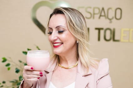 Gi Toledo in her office holding a delicious shake